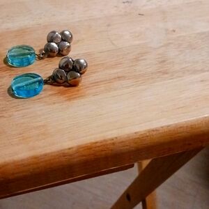 Beautiful silver tone earrings with blue stones at the bottom